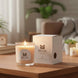 Matilda Scent candle and packaging on a wooden surface with a blurred indoor background