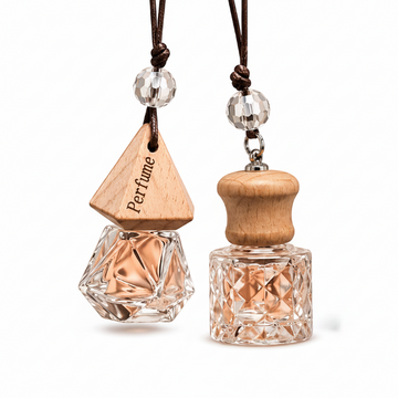 Two perfume car diffusers with wooden and crystal designs on a white background