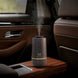 Car interior with a humidifier on the center console emitting steam.